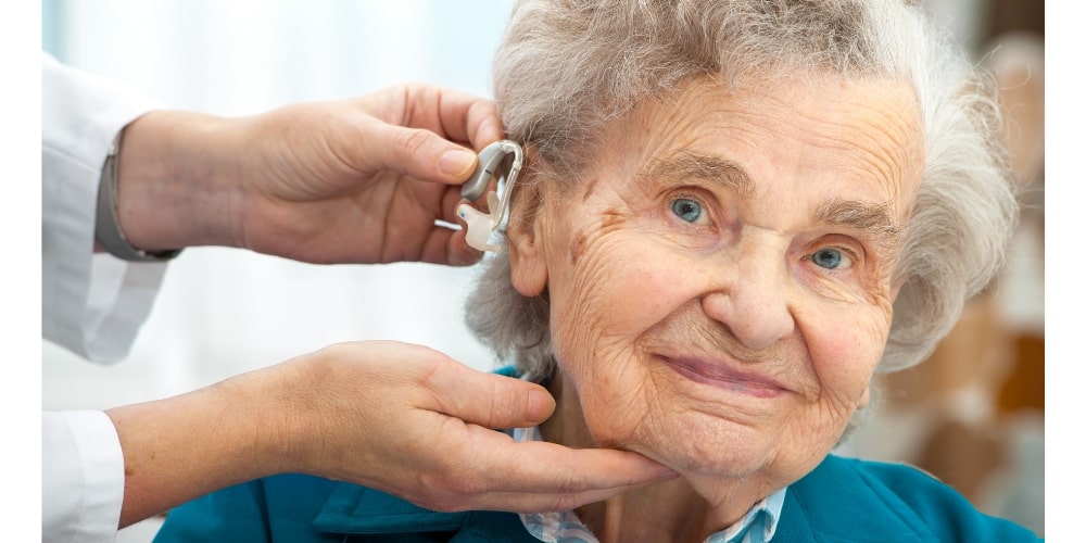An older woman undergoing a medical examination by a doctor, with a focus on her pristine hearing.