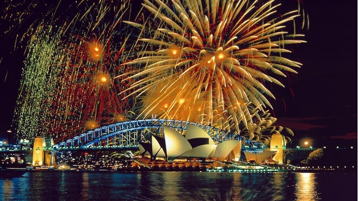 Fireworks illuminate Sydney Harbour Bridge against the night sky, creating a stunning display.