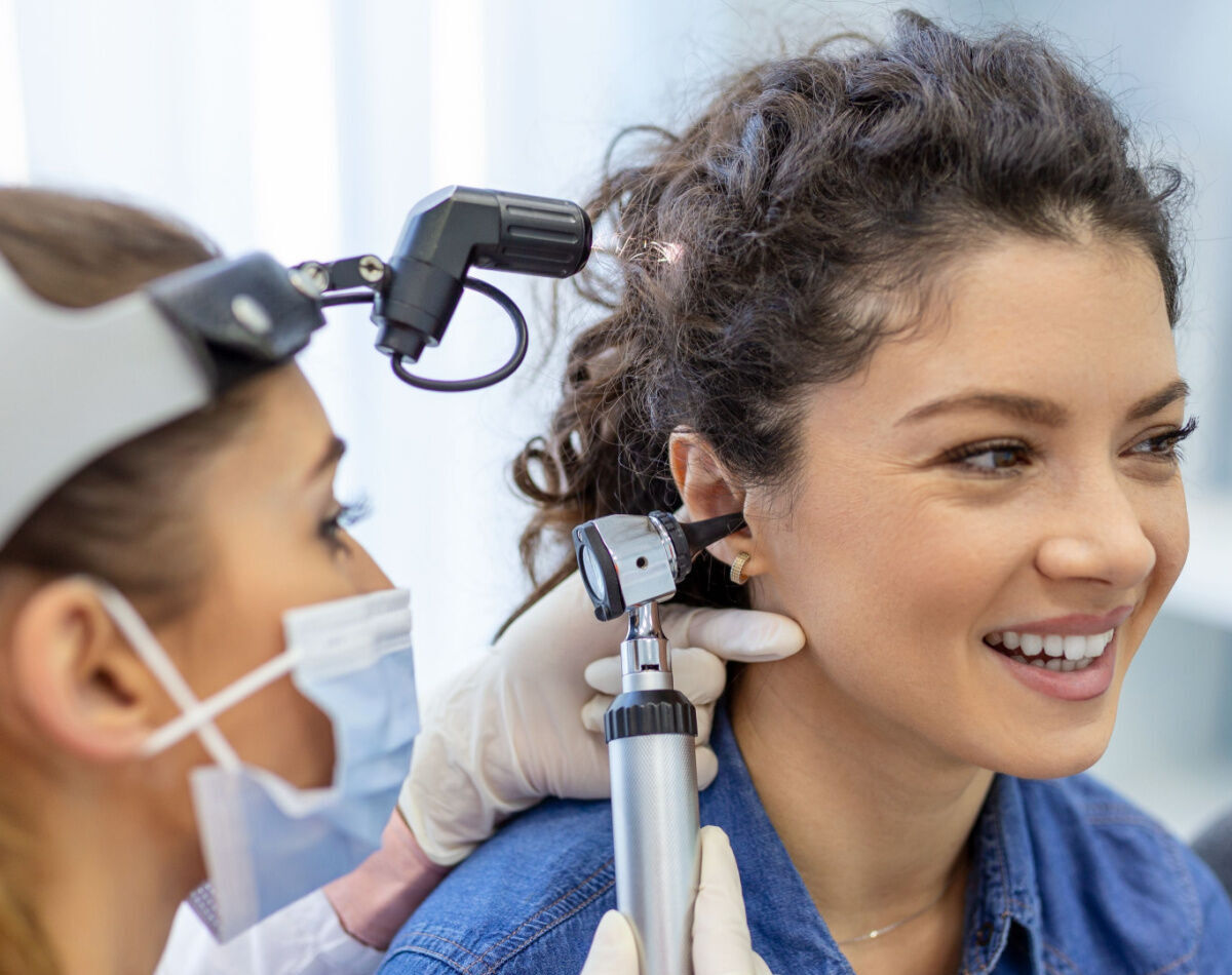 Audiologist in Perth examining a patient's ear